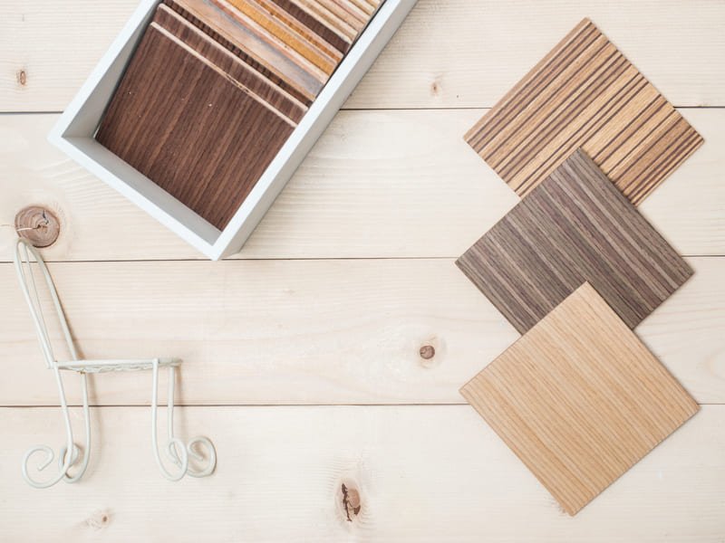A selection of different wood types, including hardwood and softwood, displayed for furniture manufacturing, showcasing texture and grain variations.