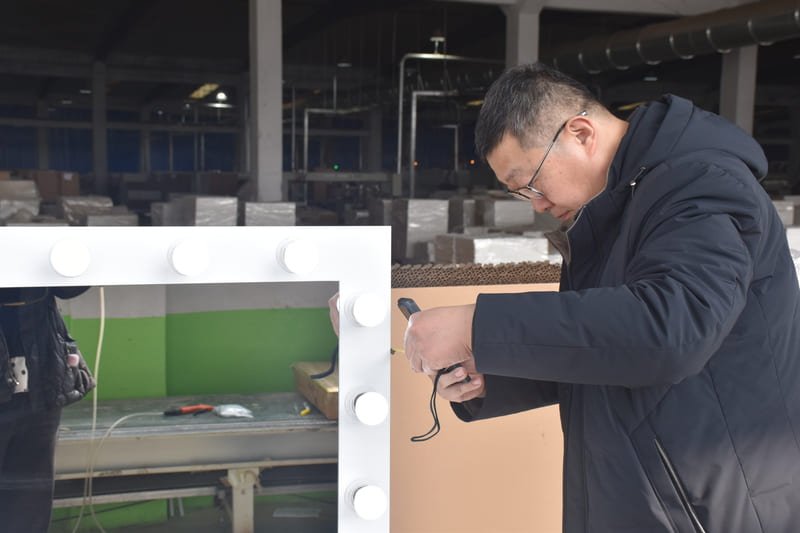 Quality inspection of MDF dressing tables in factory, checking drawer alignment, finish, and structural integrity.