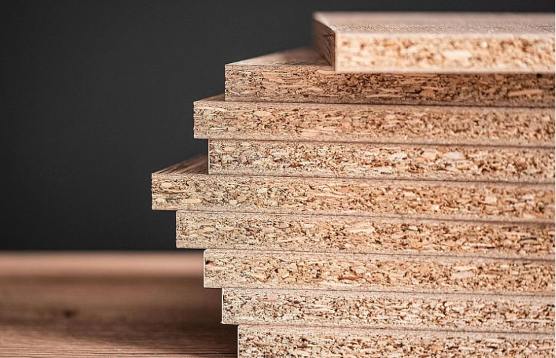 Swollen MDF board edge showing water damage compared to a sealed, moisture-resistant sample