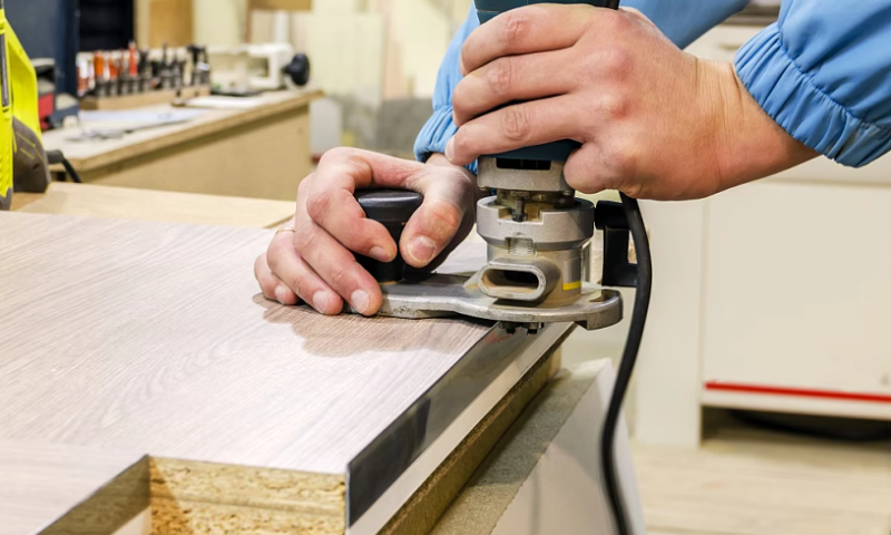 QA technician laser-scanning MDF panel for thickness consistency in factory setting