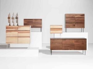 Contemporary light wood-grain chipboard desk and shelving unit with clean lines, showcasing affordable flat-pack furniture assembly.