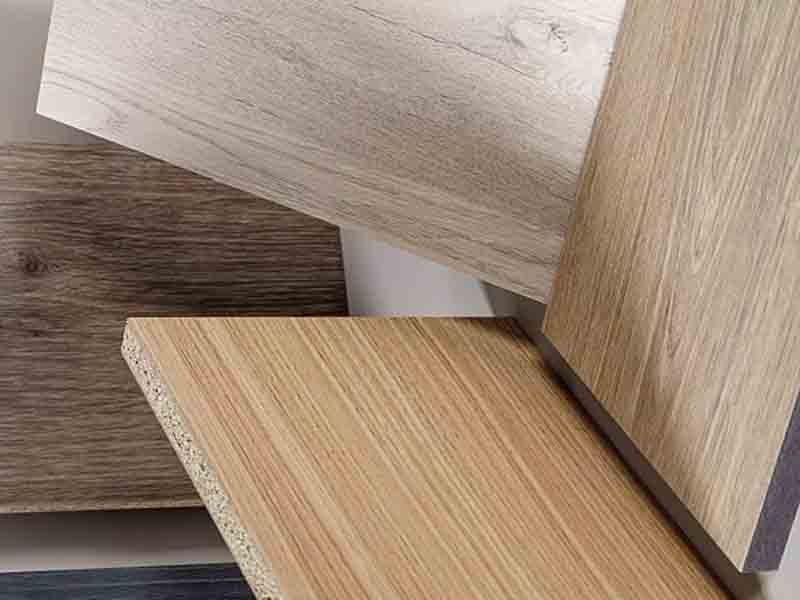 Textured close-up of matte laminate finish on chipboard desk surface showing seamless edge banding – durable indoor furniture protection