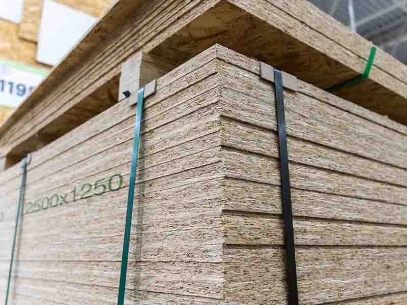 Cross-section view of chipboard showing layered wood particles bonded with resin – engineered wood material for affordable furniture cores