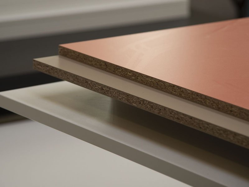 Fire-resistant MDF panels stacked in a warehouse for safe interior construction applications.