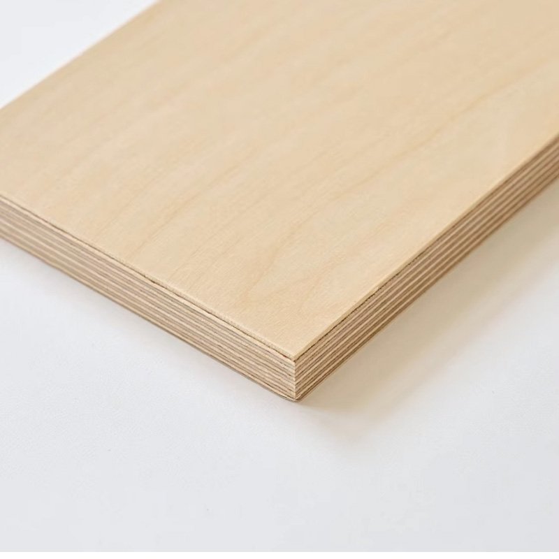 Close-up of smooth, high-quality furniture grade plywood sheet with fine wood grain detail.